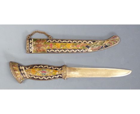 A brass knife or dagger with enamel decoration featuring a double headed bird to the handle and scabbard, 27cm long