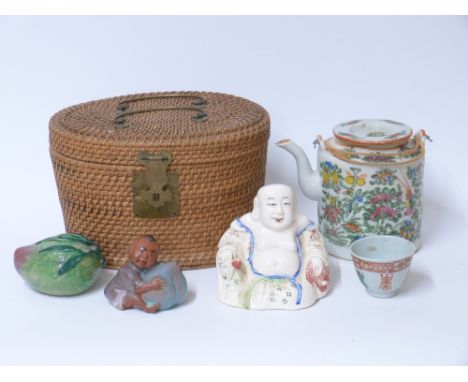 A famille rose tea pot and cup in wicker carrier, a Chinese Buddha and two further oriental ceramic items