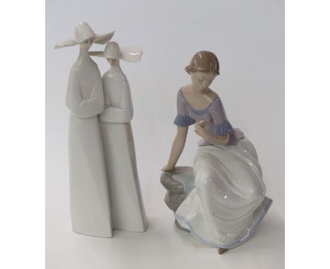 Lladro figural group of two nuns and a Nao figurine of a girl with flowers