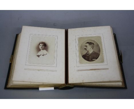 A LATE VICTORIAN LEATHER BOUND PHOTOGRAPH ALBUM, containing approximately forty two portrait photographs of children, family 