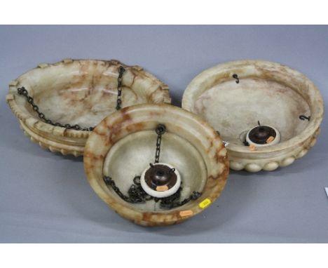 THREE EARLY 20TH CENTURY ALABSTER CEILING LIGHT SHADES, of circular form, with chains and fixing, diameters 43cm, 25.5cm and 