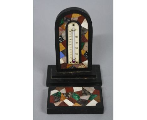 AN ASHFORD MARBLE DESK THERMOMETER, the thermometer supported on dome topped specimen inlaid arch on stepped plinth, approxim