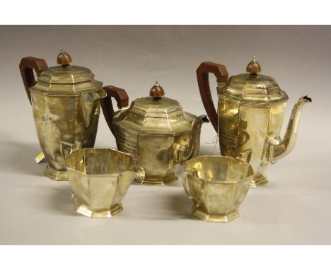 A SILVER FIVE PIECE PRESENTATION TEA SERVICE, of octagonal footed form, comprising twin handled sugar bowl, milk jug, two hot