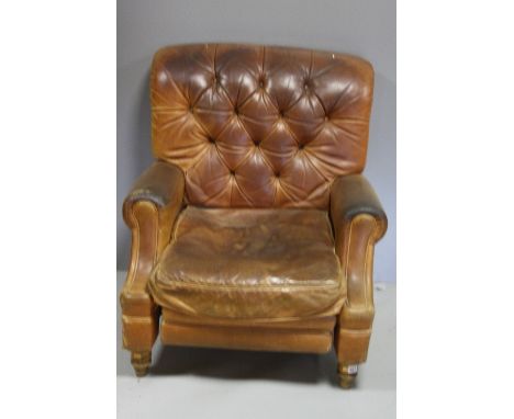 A BROWN LEATHER RECLINING CHAIR, having button back, scroll arm supports over turned front and splayed back feet