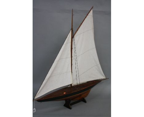 A PAIR OF WOODEN MODEL YACHTS ON STANDS, both with sails at full mast, approximate height 106cm x length 109cm (2)
