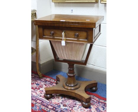 A 19TH CENTURY MAHOGANY SEWING TABLE, with fold-over top, single storage compartment on turned pillar support and quatrefoil 