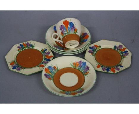 A CLARICE CLIFF BIZARRE CROCUS PATTERN PART TEASET, comprising a cup, four saucers diameters approximately 14.5cm, (one s.d. 