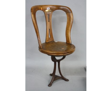 A LATE 19TH/EARLY 20TH CENTURY REVOLVING SHIPS CHAIR, with iron tripod base, 'R.M.S. Mauretania' brass plaque attached (s.d.,