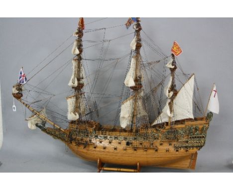 A 20TH CENTURY WOODEN AND METAL MODEL OF 'SOVEREIGN OF THE SEAS', a 17th Century Warship with sails hoisted, on a wooden stan