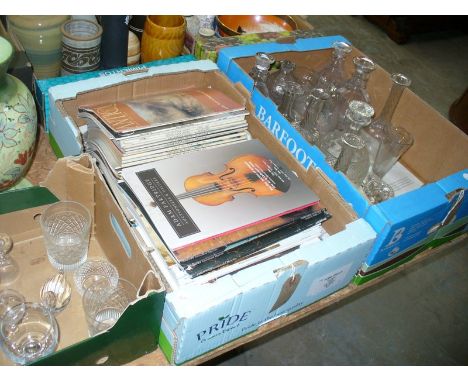 Two trays of assorted glassware including a candlestick, various decanters and a box of auction catalogues and reference book