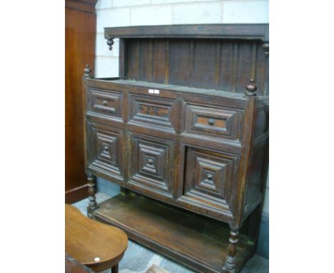 A 17th Century and later oak Flemish court cupboard The raised back with a plain frieze above two sphere and acorn shaped fin