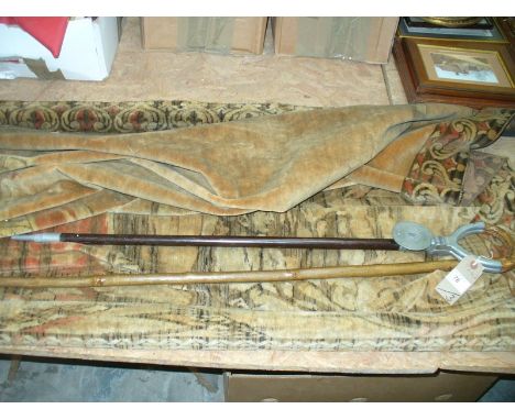A shooting stick, horn handled walking stick and a wall hanging depicting figures.