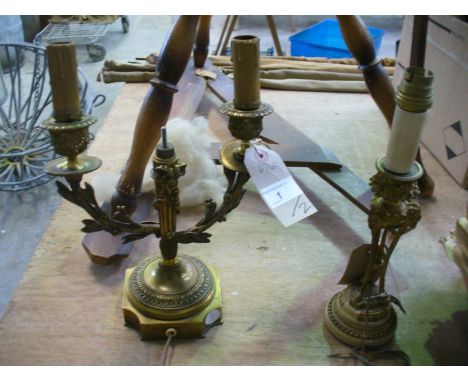 A group of 19th Century French gilt metal candlesticks, both converted to electricity, the first a two branch candelabrum, th