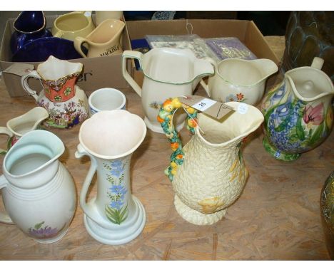 A Clarice Cliff relief moulded " Celtic Harvest" jug, two Radford floral pattern jugs in pastel shades, a Masons " Oriental G