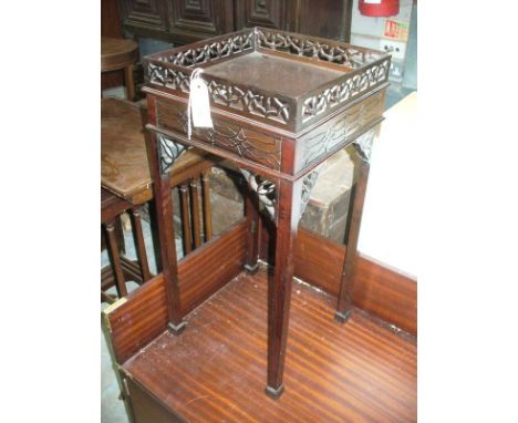 A Mahogany Chippendale style wine table with an open work gallery and blind fretwork frieze.