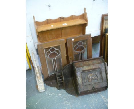 A Pine wall shelf, a carved oak hanging corner cupboard the single door carved with a knights mask  and a pair of glazed cupb