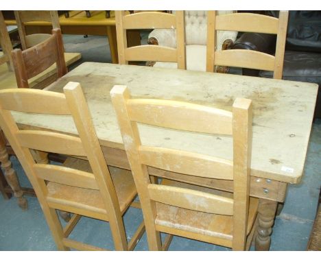 A Rectangular pine kitchen table and 4 contemporary beech wood ladder back chairs.