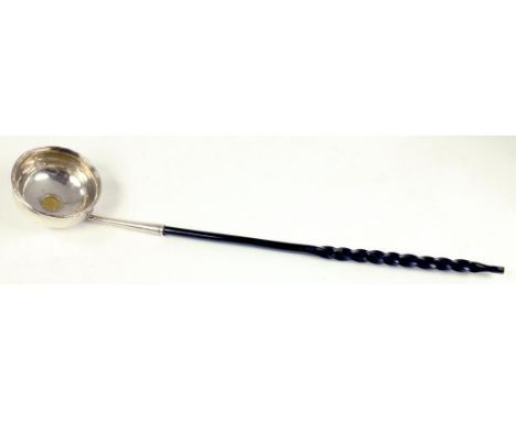 A SILVER PUNCH LADLE, THE BOWL INSET WITH A SPANISH GOLD HALF ESCUDO 1754, TWISTED BALEEN HANDLE