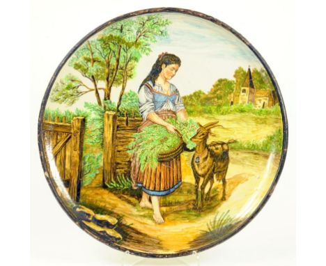 AN ITALIAN MIOLICA CHARGER, PAINTED WITH A PEASANT GIRL AND GOAT BY A GATE, LATE 19TH C