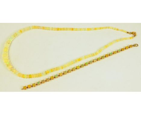 AN OPAL SET GOLD LINE BRACELET AND A NECKLACE OF OPAL BEADS