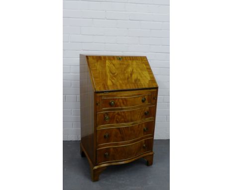 A mahogany bureau, the fall front with pull out slides over four serpentine drawers on bracket supports, 95 x 55cm