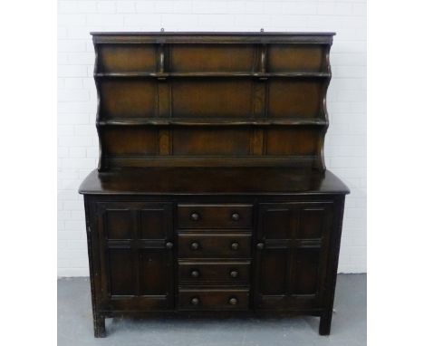 Ercol style dark elm dresser with a shelved plate back over a panelled cupboard door base, 170 x 145 cm