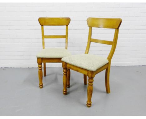 A pair of light oak tablet back hardwood side chairs with upholstered seats on turned supports (2) 