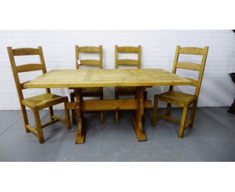 A five piece Country Pine dining set comprising a plank top table on trestle supports, together with a set of four ladder bac