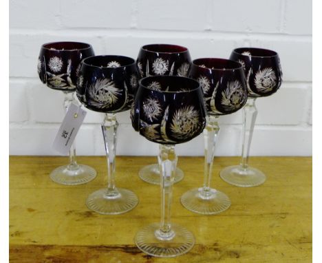 A set of six wine glasses, the ruby coloured bowls with star cut decoration on facet stems and circular foots (6)