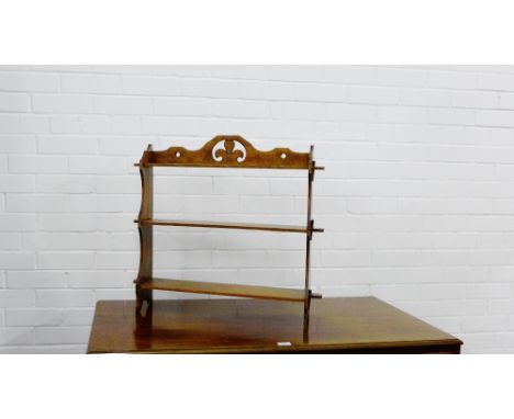 A mahogany three tier open shelf with fleur de lys to top, 62 x 62cm