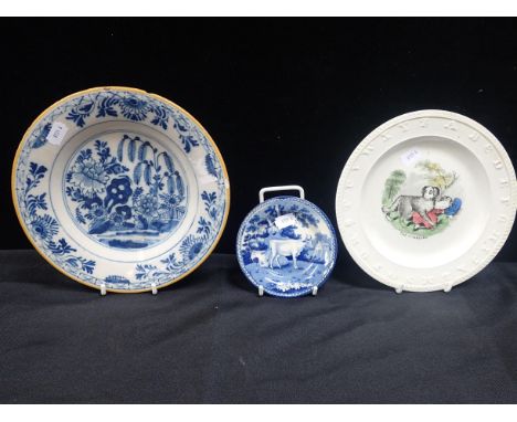 A DUTCH DELFTWARE PLATE with two early Victorian Staffordshire childrens' plates