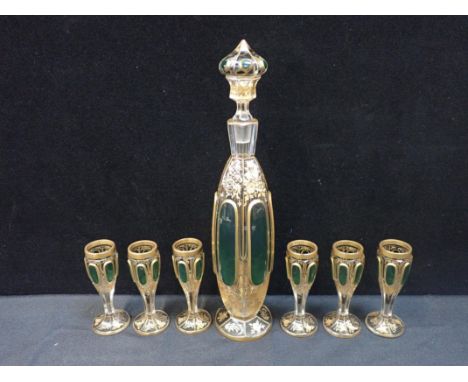 A 19th CENTURY BOHEMIAN OVERLAID GLASS LIQUEUR SET in the style of Lobmeyr or Moser, with green panels and wheel-engraved and