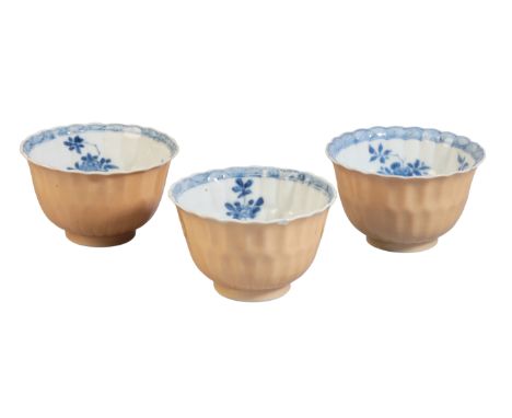 THREE CHINESE CAFE AU LAIT TEA BOWLS Kangxi, each of lobed form, decorated in blue and white to the inside with sprays of flo