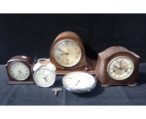 FIVE CLOCKS, INCLUDING A SMITHS BULKHEAD CLOCK two Bakelite clocks, a 'Napoleon Hat' clock with Westminster/Whittington chime