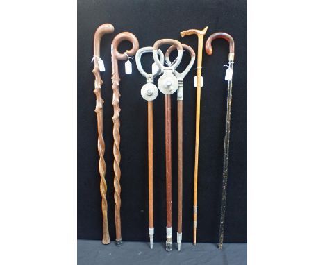 TWO ALPINE WALKING STICKS WITH TWISTED SHAFTS a Nordic folk art horse stick signed 'Keckner', three shooting sticks, two by M