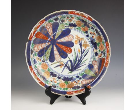 A Chinese porcelain imari charger, Kangxi (1661-1722) the circular charger with ogee rim enclosing a central floral flowering