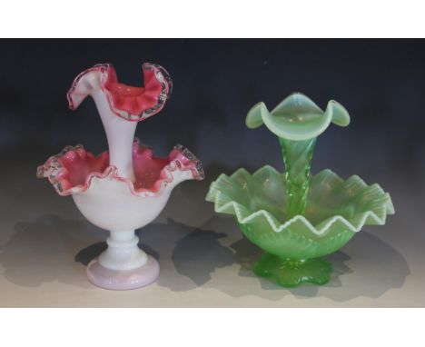 A green glass epergne, the single trumpet over a shaped base, 32cm high, with three further similar examples in pink, pale bl