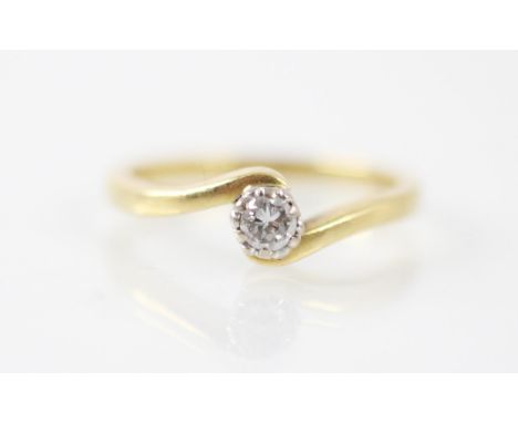 A 18ct yellow gold and diamond ring, the central round cut diamond within white metal setting edge upon a twist designed head