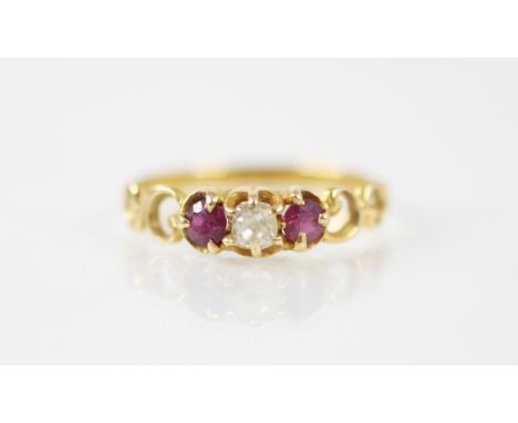 An early 20th century untested ruby and diamond ring, the central rose cut diamond with a round cut ruby to each side, within