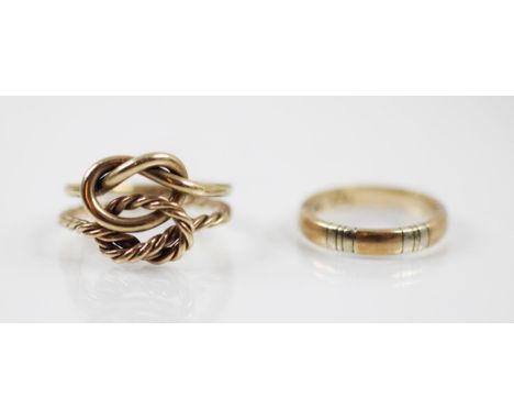 A 9ct yellow gold double knot ring, with one plain polished knot and the other with rope twist detail leading to conforming s