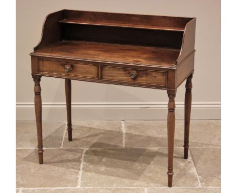 A George IV mahogany tray top washstand, the three quarter gallery with integral shelf, over a pair of cedar lined frieze dra