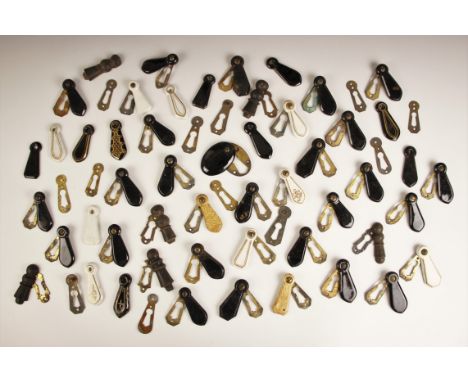 A collection of brass door escutcheons with sliding ceramic key hole covers, including Japanned and simulated horn examples (