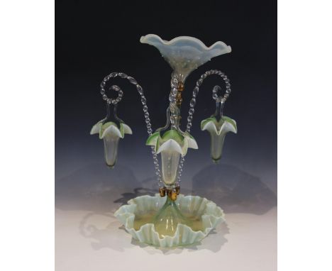 A vaseline glass epergne, with a central trumpet over three lower canes supporting hanging baskets, all with green crimped gl