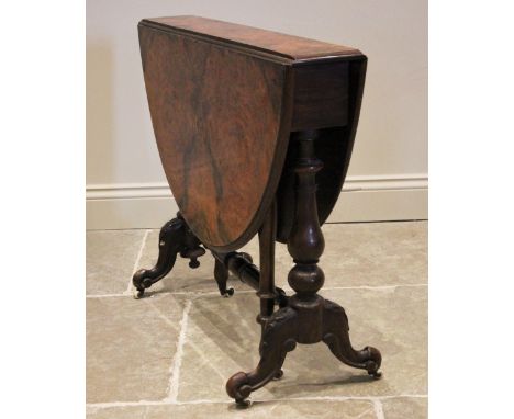 A Victorian figured walnut Sutherland table, the moulded oval drop leaf top upon baluster and bulbous supports, leaf carved d