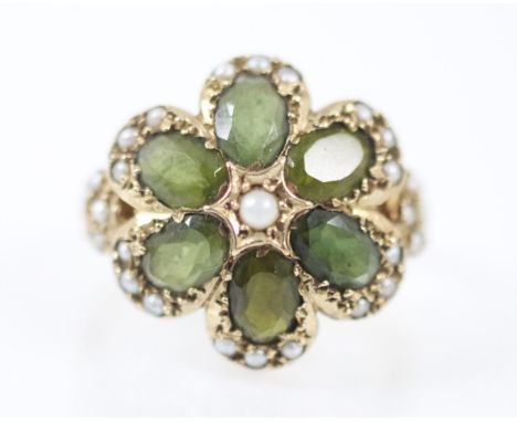 A Victorian style untested tourmaline and seed pearl ring, the six oval cut tourmalines designed within a flowerhead mount wi