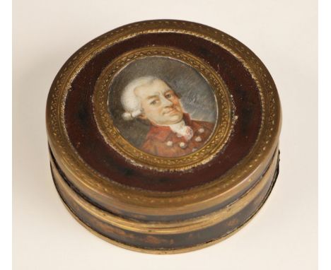 A gilt brass mounted and tortoiseshell lined papier mache snuff box and cover, 19th century, of circular form, the cover set 