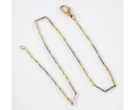 An early 20th century two tone necklace/bracelet, the white and yellow metal elongated box links with twist detail, one jump 