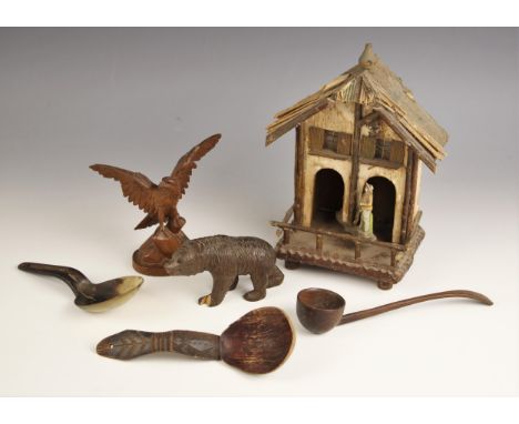 A selection of treen items, including a Black Forest carved wooden spoon, the terminal with chevron detail leading to a carvi