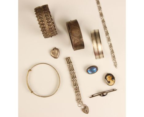 A selection of silver jewellery, including two silver Victorian bangles of Aesthetic movement design, a silver gate link brac