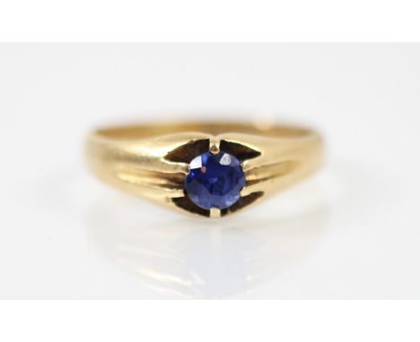 A 20th century synthetic sapphire 18ct yellow gold ring, the round cut synthetic sapphire within a yellow gold claw set gypsy